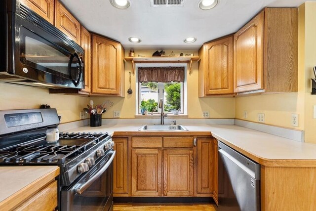 12 Clarner Rd, Lynn, MA 01904 - kitchen featuring range with gas stovetop, dishwasher, black microwave, light countertops, and recessed lighting