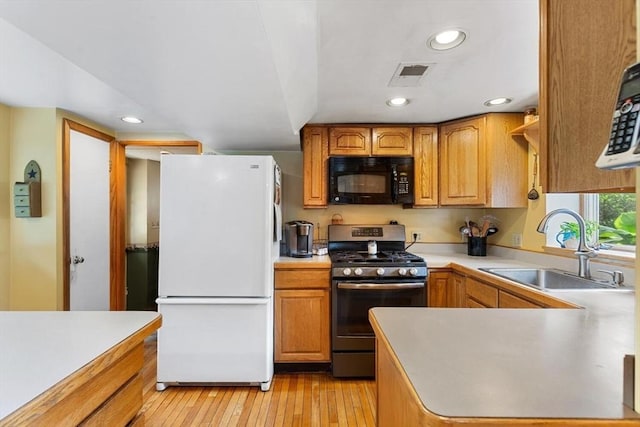 12 Clarner Rd, Lynn, MA 01904 - kitchen featuring freestanding refrigerator, stainless steel gas range oven, black microwave, recessed lighting, and light wood finished floors