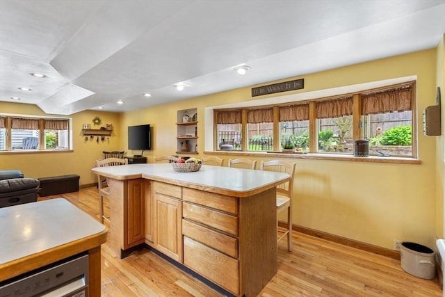 12 Clarner Rd, Lynn, MA 01904 - kitchen featuring a breakfast bar area, open floor plan, light wood-style floors, light countertops, and a kitchen island