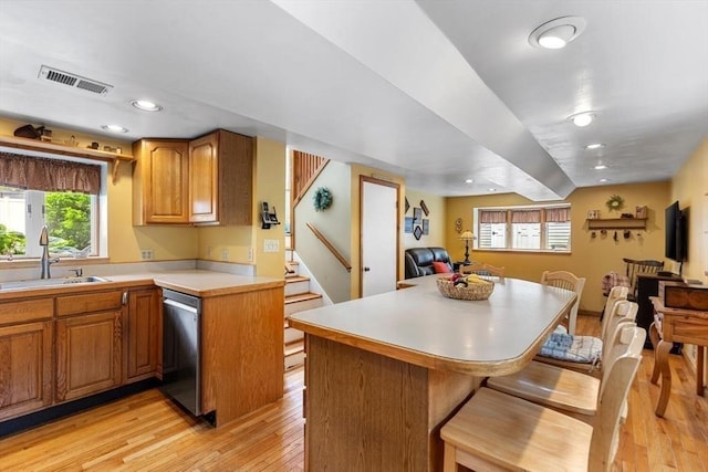 12 Clarner Rd, Lynn, MA 01904 - kitchen featuring dishwasher, open floor plan, light wood-style floors, light countertops, and a breakfast bar area