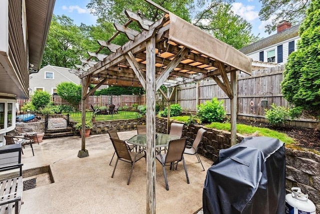 12 Clarner Rd, Lynn, MA 01904 - fenced backyard with a pergola, outdoor dining area, a grill, and a patio area