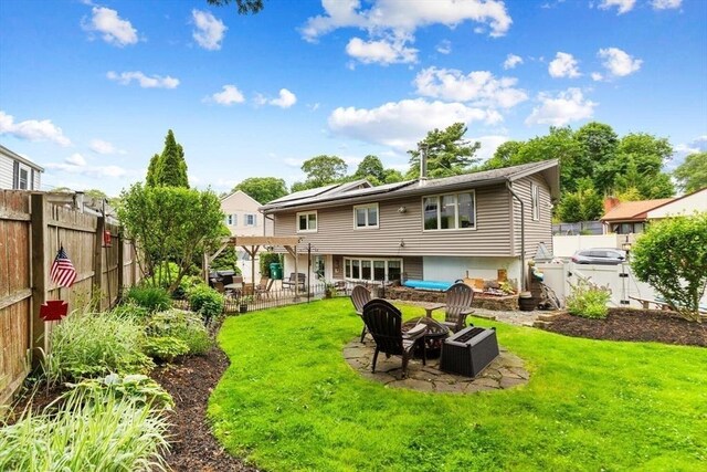 12 Clarner Rd, Lynn, MA 01904 - rear view of house with an outdoor fire pit, a patio area, a pergola, and a fenced backyard