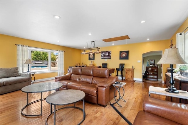 12 Clarner Rd, Lynn, MA 01904 - living room featuring light wood-style flooring, arched walkways, recessed lighting, and attic access