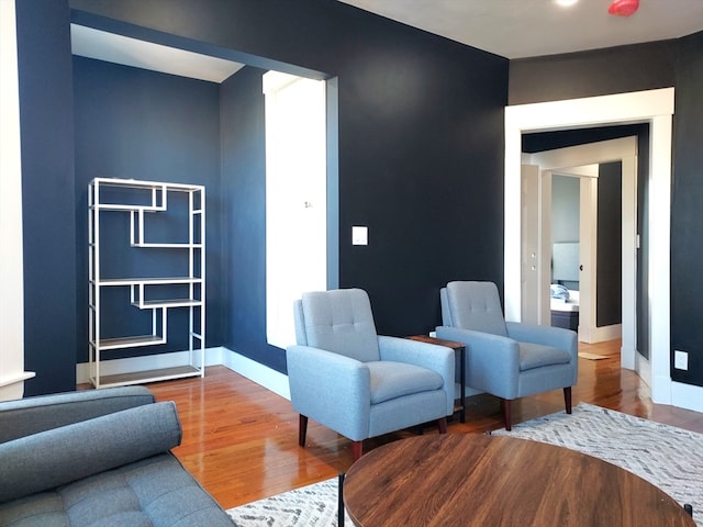 sitting room with dark hardwood / wood-style flooring