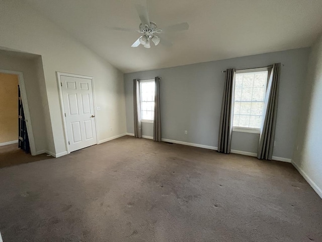 unfurnished bedroom with lofted ceiling, carpet flooring, ceiling fan, and baseboards