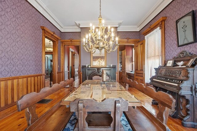 4 W Broadway, Gardner, MA 01440 - dining area with a notable chandelier, wallpapered walls, a wainscoted wall, and crown molding