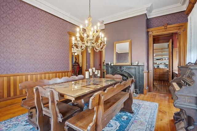 4 W Broadway, Gardner, MA 01440 - dining space with a notable chandelier, wallpapered walls, a wainscoted wall, and light wood-style flooring