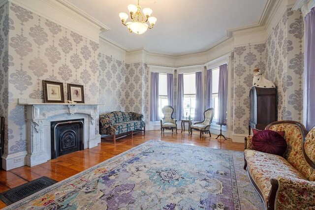 4 W Broadway, Gardner, MA 01440 - living area featuring baseboards, ornamental molding, a chandelier, a fireplace, and wood finished floors