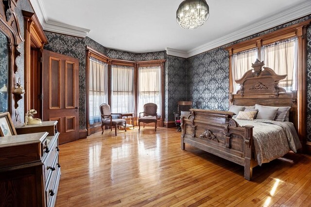 4 W Broadway, Gardner, MA 01440 - bedroom with an inviting chandelier, multiple windows, light wood-type flooring, and wallpapered walls