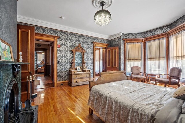 4 W Broadway, Gardner, MA 01440 - bedroom with wallpapered walls, light wood finished floors, baseboards, and an inviting chandelier