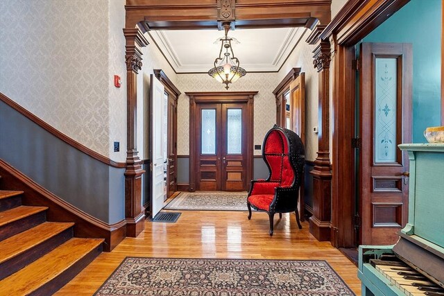 4 W Broadway, Gardner, MA 01440 - entryway featuring wallpapered walls, wood finished floors, ornamental molding, and stairs