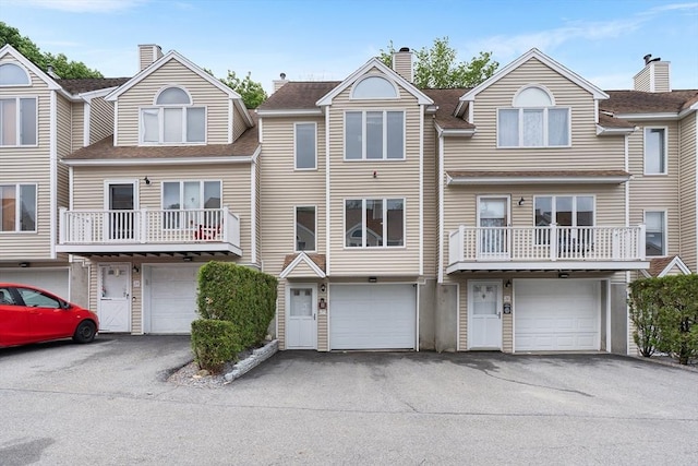 36 Tobey Rd Unit 25, Dracut, MA 01826 - townhome / multi-family property with a garage, driveway, a chimney, and roof with shingles