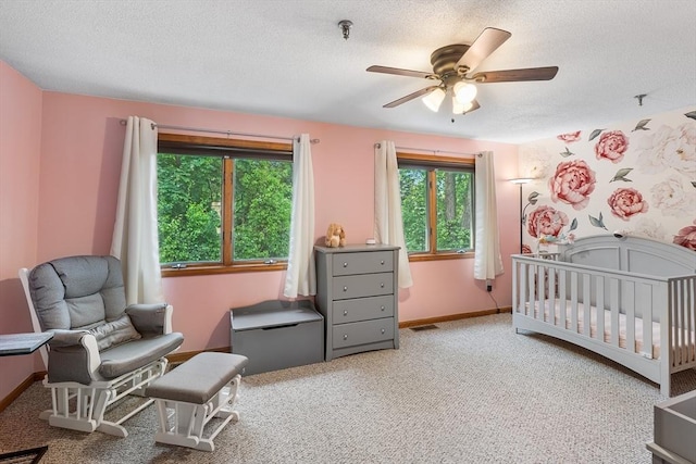 36 Tobey Rd Unit 25, Dracut, MA 01826 - bedroom featuring carpet flooring, a textured ceiling, a nursery area, baseboards, and a ceiling fan