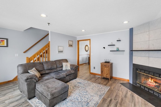 36 Tobey Rd Unit 25, Dracut, MA 01826 - living area with baseboards, wood finished floors, stairway, a fireplace, and recessed lighting