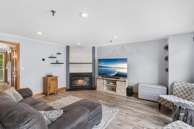 36 Tobey Rd Unit 25, Dracut, MA 01826 - living room featuring baseboards, wood finished floors, a fireplace, and recessed lighting