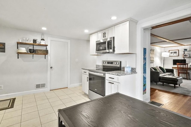 114 Linebrook Rd, Ipswich, MA 01938 - kitchen featuring appliances with stainless steel finishes, white cabinets, baseboards, light tile patterned floors, and recessed lighting