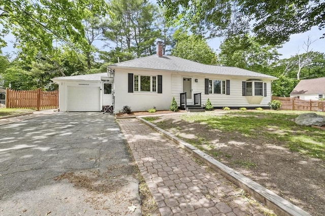 114 Linebrook Rd, Ipswich, MA 01938 - single story home featuring a chimney, asphalt driveway, and an attached garage