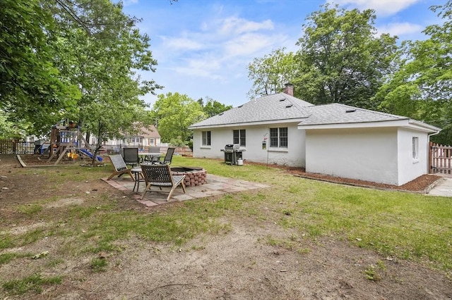 114 Linebrook Rd, Ipswich, MA 01938 - back of property with a playground, a patio, stucco siding, roof with shingles, and a chimney