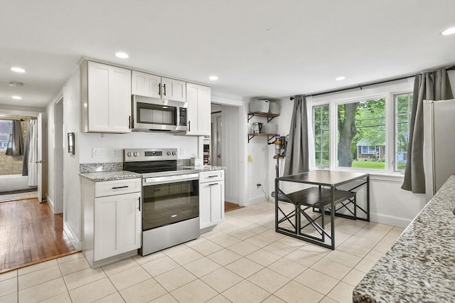 114 Linebrook Rd, Ipswich, MA 01938 - kitchen featuring stainless steel appliances, baseboards, light tile patterned flooring, plenty of natural light, and recessed lighting