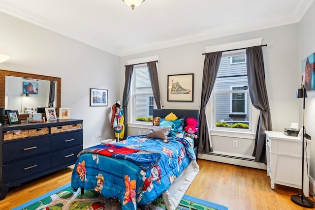 bedroom with light hardwood / wood-style floors, ornamental molding, and a baseboard radiator