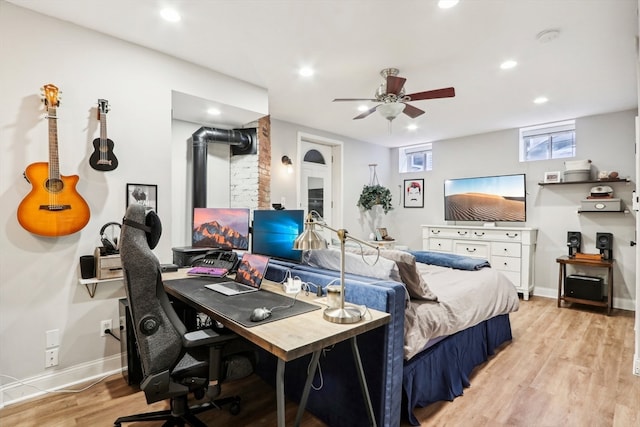 bedroom with light hardwood / wood-style floors and ceiling fan