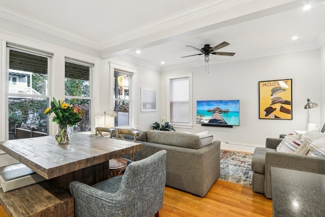 living room featuring a healthy amount of sunlight, crown molding, hardwood / wood-style flooring, and ceiling fan