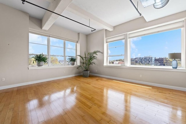51 Lafayette St Unit 304, Salem, MA 01970 - spare room featuring beam ceiling, baseboards, and hardwood / wood-style flooring