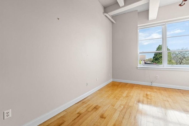 51 Lafayette St Unit 304, Salem, MA 01970 - empty room featuring light wood-type flooring, baseboards, and beamed ceiling