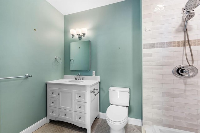 51 Lafayette St Unit 304, Salem, MA 01970 - bathroom featuring tiled shower, toilet, vanity, baseboards, and tile patterned flooring