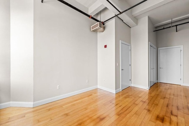 51 Lafayette St Unit 304, Salem, MA 01970 - spare room with hardwood / wood-style floors, baseboards, and a high ceiling