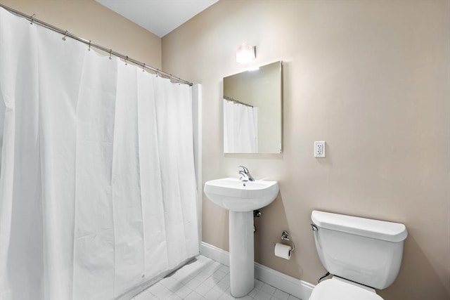 51 Lafayette St Unit 304, Salem, MA 01970 - bathroom featuring toilet, tile patterned flooring, baseboards, and a shower with shower curtain