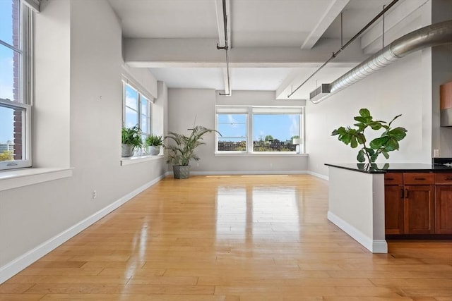 51 Lafayette St Unit 304, Salem, MA 01970 - unfurnished dining area with beamed ceiling, light wood-style floors, and baseboards