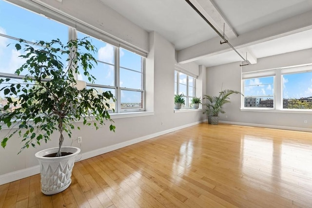 51 Lafayette St Unit 304, Salem, MA 01970 - unfurnished room with beam ceiling, hardwood / wood-style floors, and baseboards