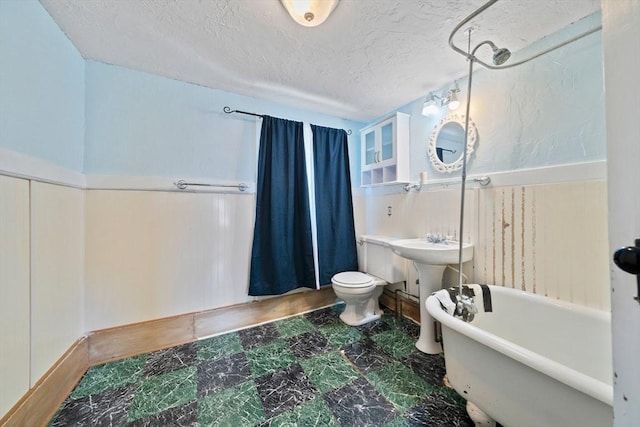 2 Eastern Ave, Hull, MA 02045 - bathroom featuring a freestanding tub, marble finish floors, a textured ceiling, and a shower with curtain