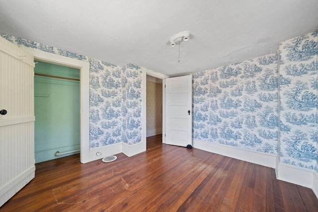 2 Eastern Ave, Hull, MA 02045 - unfurnished bedroom featuring wallpapered walls, wood finished floors, and a closet