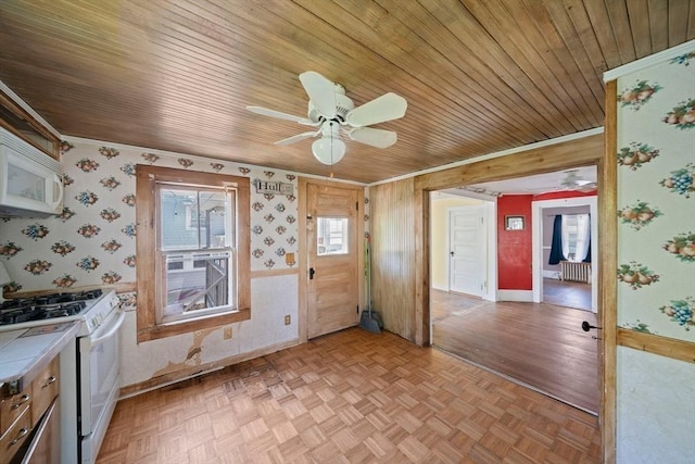 2 Eastern Ave, Hull, MA 02045 - kitchen with white appliances, crown molding, wooden ceiling, a ceiling fan, and radiator heating unit