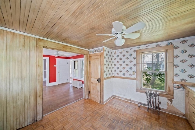 2 Eastern Ave, Hull, MA 02045 - unfurnished room featuring ceiling fan, wallpapered walls, radiator heating unit, wooden ceiling, and wooden walls
