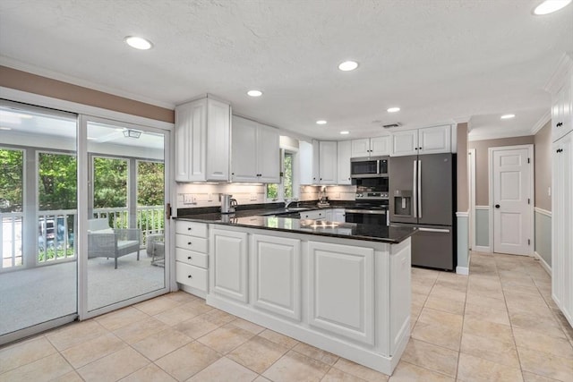 48 Pine Hill Dr, Walpole, MA 02081 - kitchen featuring stainless steel appliances, ornamental molding, white cabinetry, a peninsula, and recessed lighting