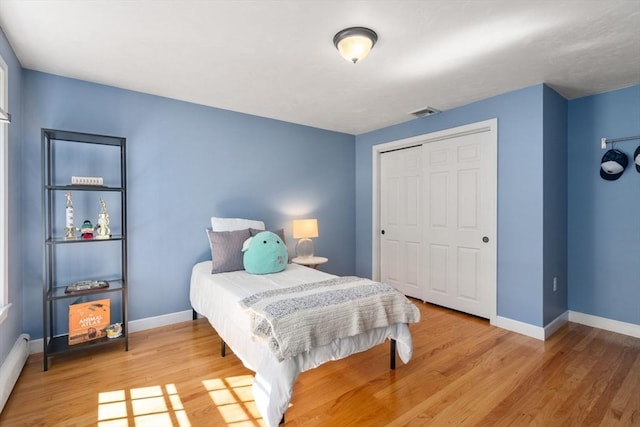 48 Pine Hill Dr, Walpole, MA 02081 - bedroom featuring baseboards, wood finished floors, a closet, and a baseboard heating unit
