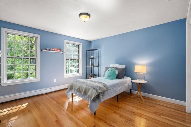 48 Pine Hill Dr, Walpole, MA 02081 - bedroom featuring multiple windows, baseboard heating, baseboards, and wood finished floors