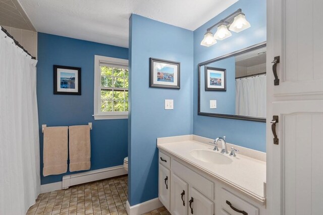 48 Pine Hill Dr, Walpole, MA 02081 - bathroom with a baseboard radiator, baseboards, vanity, and toilet
