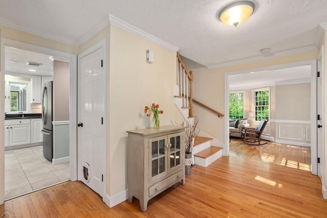 48 Pine Hill Dr, Walpole, MA 02081 - hall with stairway, light wood-style floors, and ornamental molding