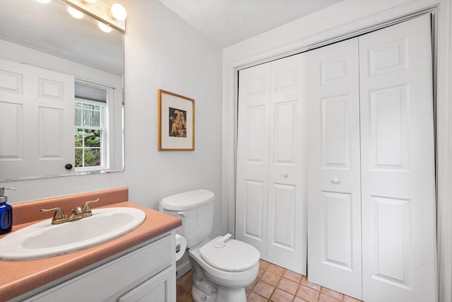 bathroom featuring a closet, vanity, and toilet
