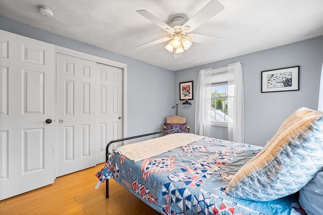 bedroom featuring wood finished floors, a closet, and ceiling fan