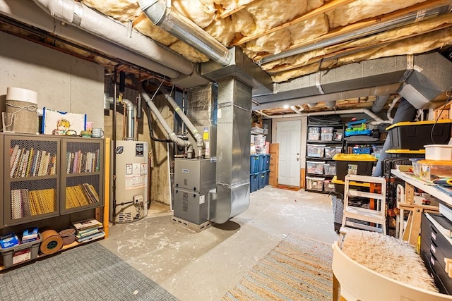 unfinished below grade area featuring water heater and heating unit
