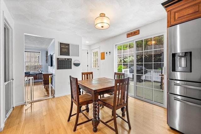 dining room with light wood-style floors and baseboards