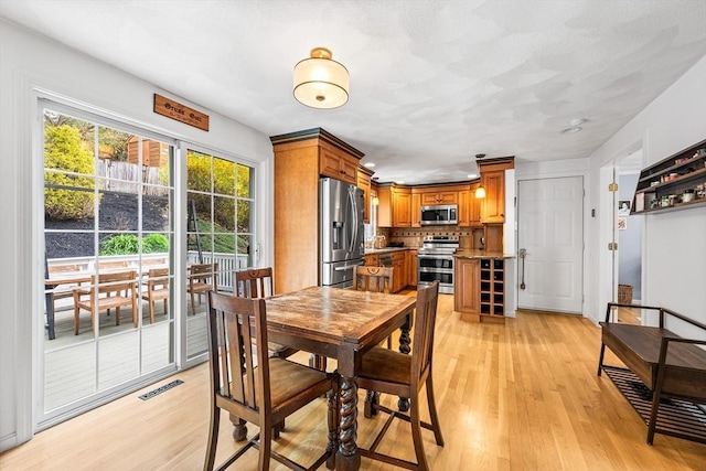 dining area with light wood finished floors