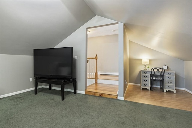 bonus room featuring carpet, a baseboard heating unit, and vaulted ceiling