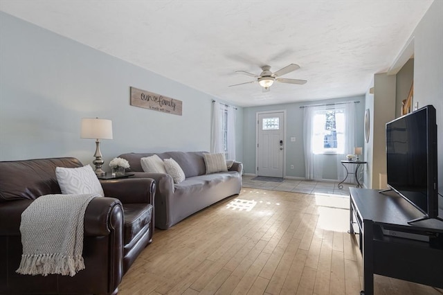 living room with ceiling fan and light hardwood / wood-style flooring