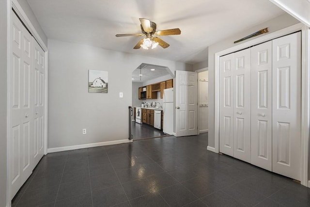 unfurnished living room with ceiling fan